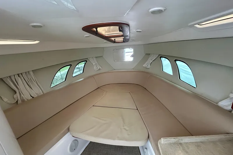 Slide: The Image of 2012 Intrepid 400 Cuddy cabin interior with beige seating and windows. - 29