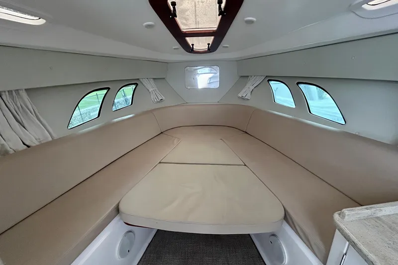 Slide: The Image of Interior of 2012 Intrepid 400 Cuddy boat with beige seating and windows. - 30