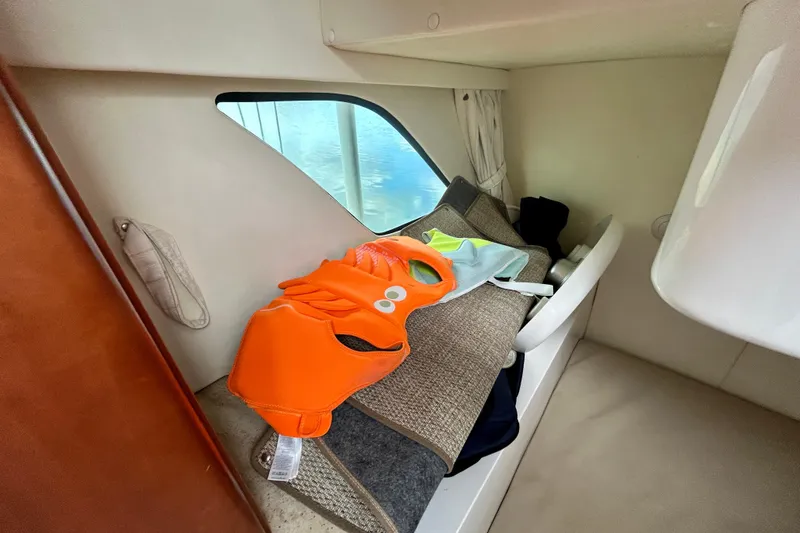 Slide: The Image of Interior of 2012 Intrepid 400 Cuddy with life jackets on a cushioned seat. - 33