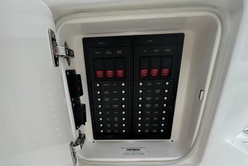 Slide: The Image of Electrical panel of a 2012 Intrepid 400 Cuddy boat, featuring labeled switches and controls. - 38
