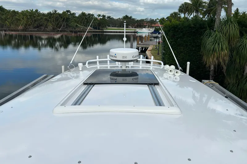 Slide: The Image of 2012 Intrepid 400 Cuddy boat with Garmin radar, docked by a scenic waterfront. - 42