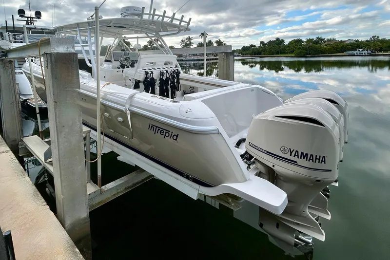 Slide: The Image of 2012 Intrepid 400 Cuddy boat with Yamaha engines docked by calm waters. - 5
