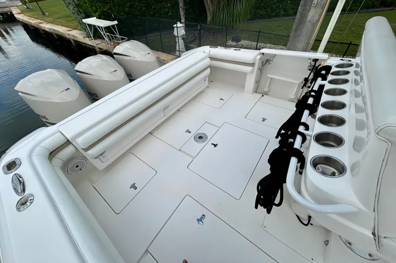 Slide: The Image of 2012 Intrepid 400 Cuddy boat deck with seating, rod holders, and Yamaha engines. - 8