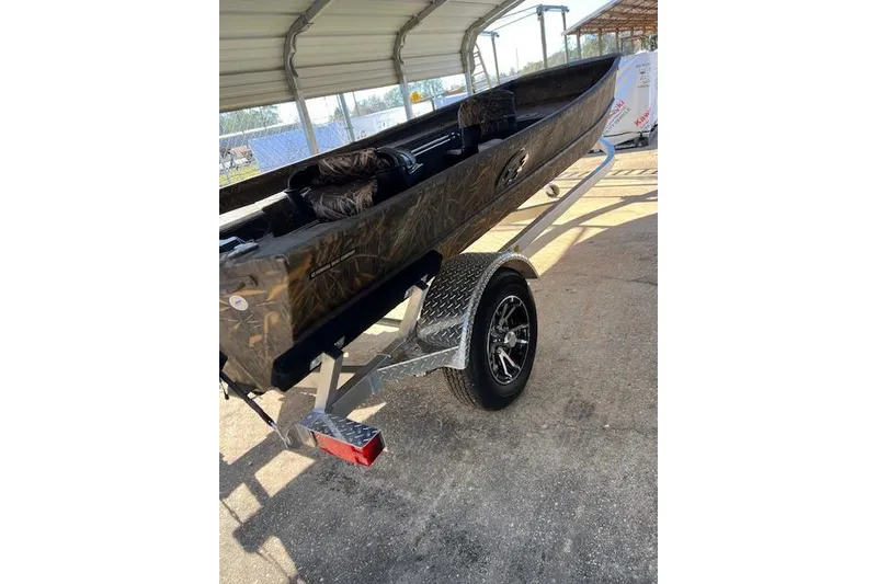 Slide: The Image of 2025 G3 Gator Tough 16 DK boat on trailer under shelter. - 3