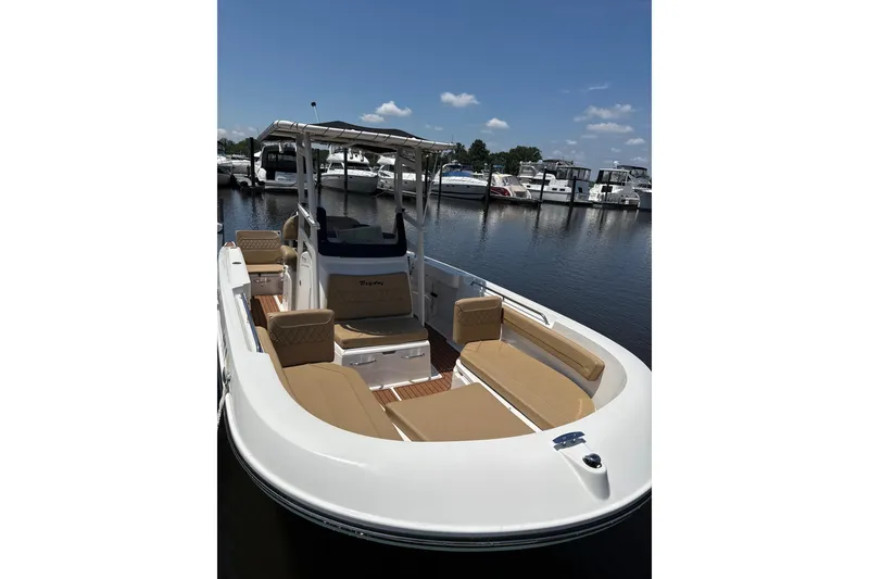 The Image of 2024 Trophy CC22 boat with tan seating, docked at a marina under a clear sky. - 1