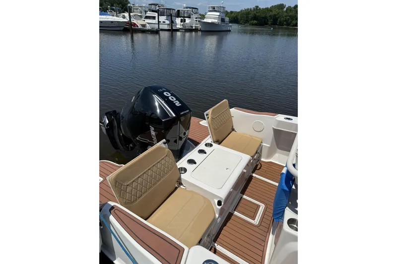 Slide: The Image of 2024 Trophy CC22 boat interior with tan seats and Mercury outboard motor. - 5