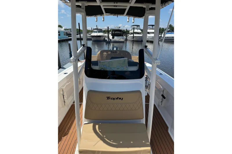 Slide: The Image of 2024 Trophy CC22 boat interior with helm, docked at marina. - 6