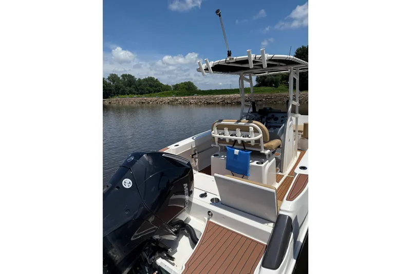 Slide: The Image of 2024 Trophy CC22 boat on calm water, featuring a sleek design and powerful engine. - 8