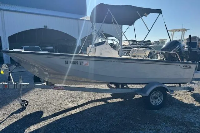 Slide: The Image of 2023 Boston Whaler 170 Montauk boat on trailer, parked outside a storage facility. - 10