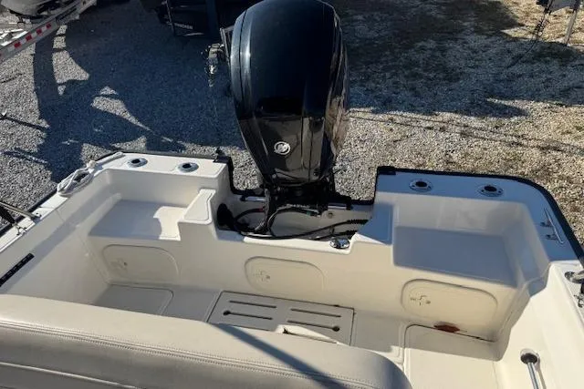 Slide: The Image of 2023 Boston Whaler 170 Montauk boat interior with outboard motor, showcasing seating and storage. - 12