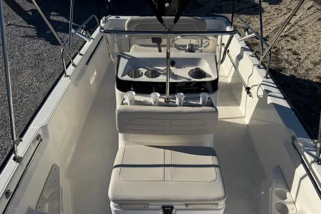 Slide: The Image of 2023 Boston Whaler 170 Montauk interior, featuring seating and console layout. - 17