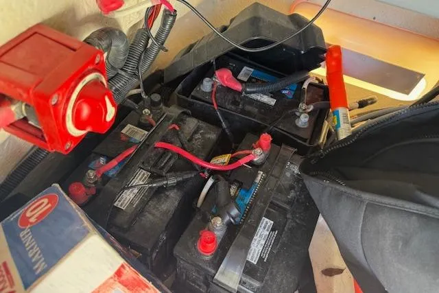 Slide: The Image of Battery compartment of a 2023 Boston Whaler 170 Montauk boat with wiring and connections. - 18