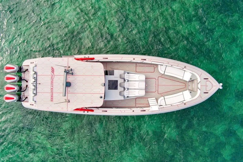 Slide: The Image of 2023 Midnight Express 43 Open boat on clear green water, aerial view. - 10