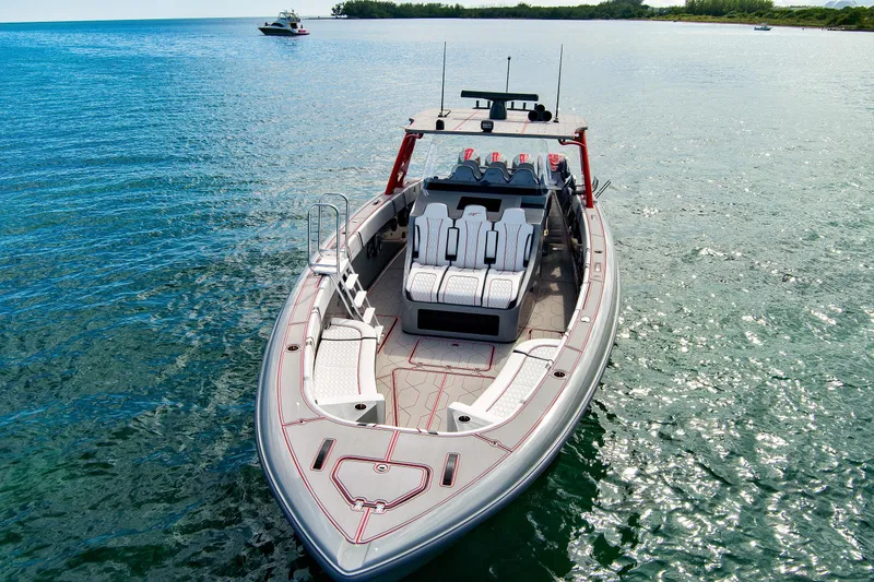 Slide: The Image of 2023 Midnight Express 43 Open boat on clear blue water, showcasing sleek design and luxury seating. - 11