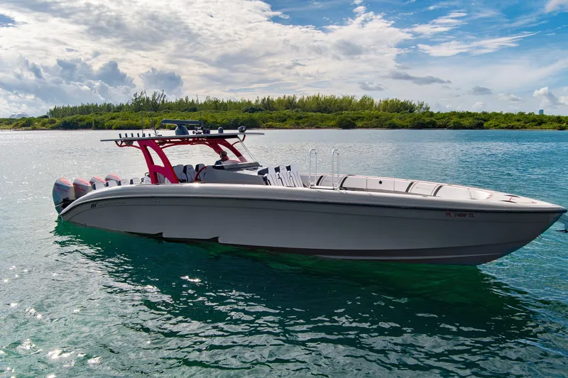 Slide: The Image of 2023 Midnight Express 43 Open boat on calm water under a partly cloudy sky. - 2