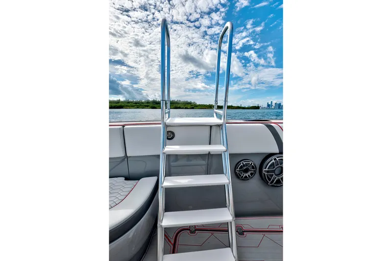 Slide: The Image of Stainless steel ladder on 2023 Midnight Express 43 Open boat, under a partly cloudy sky. - 31