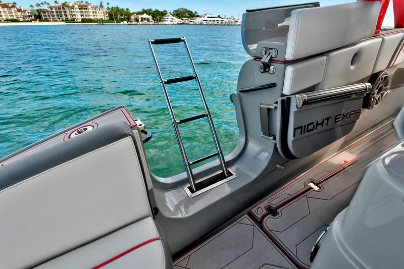 Slide: The Image of 2023 Midnight Express 43 Open boat with ladder, docked by clear blue water. - 32