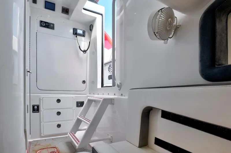 Slide: The Image of Interior of 2023 Midnight Express 43 Open boat, featuring sleek white design and modern amenities. - 35
