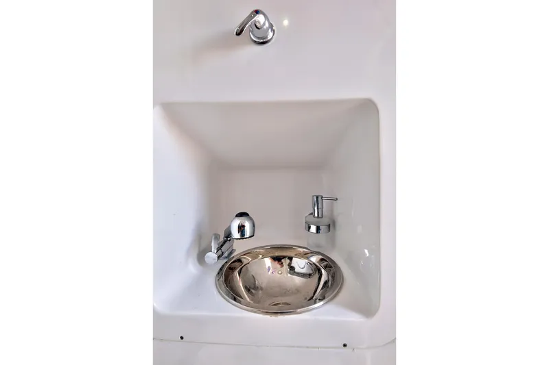 Slide: The Image of Compact sink with chrome fixtures in 2023 Midnight Express 43 Open boat. - 39