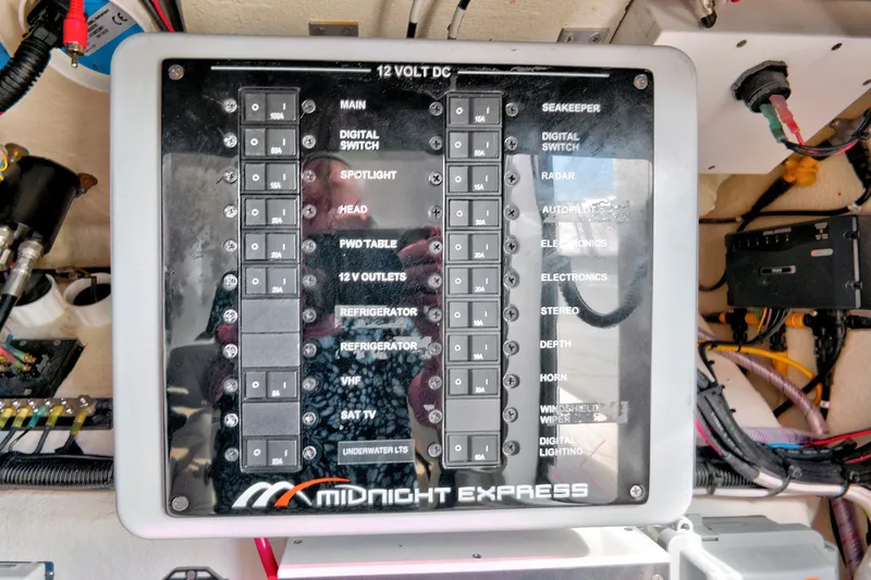 Slide: The Image of Midnight Express 43 Open 2023 boat control panel with labeled switches and wiring. - 40