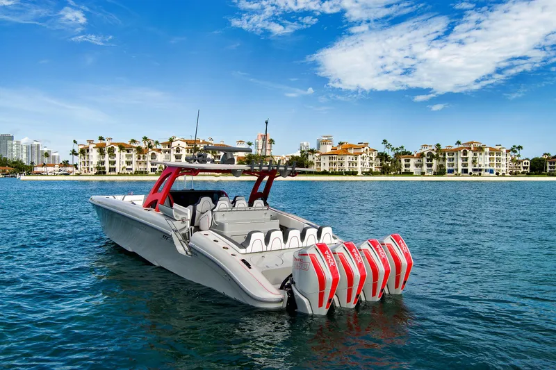 Slide: The Image of 2023 Midnight Express 43 Open boat with multiple engines on a sunny waterfront. - 5