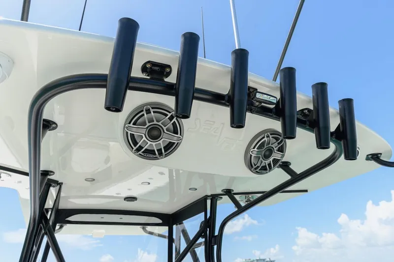 Slide: The Image of 2023 SeaVee 370Z boat with rod holders and speakers under a clear blue sky. - 15