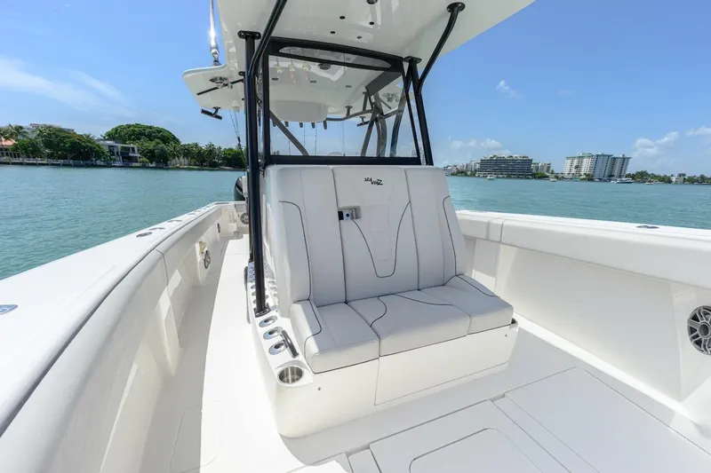Slide: The Image of 2023 SeaVee 370Z boat interior with seating, on a sunny day by the water. - 17