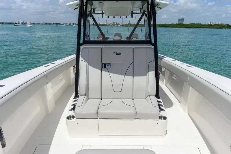 Slide: The Image of 2023 SeaVee 370Z boat interior with seating, on calm blue water. - 19