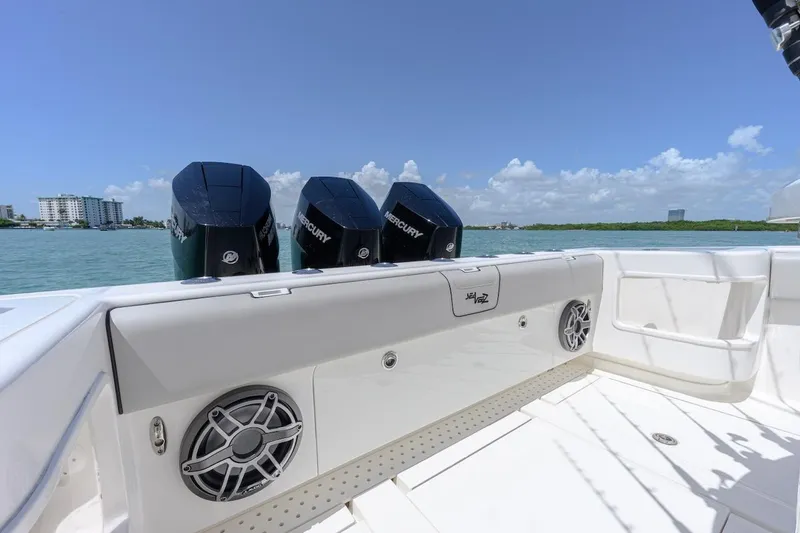 Slide: The Image of 2023 SeaVee 370Z boat with triple Mercury engines on a sunny day. - 8