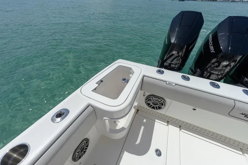 Slide: The Image of 2023 SeaVee 370Z boat with triple Mercury engines on clear water. - 9