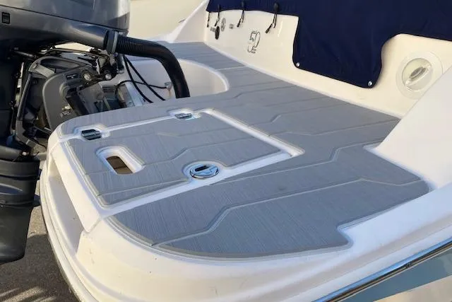 Slide: The Image of 2020 Regal 21 OBX boat with outboard motor and spacious deck area. - 13