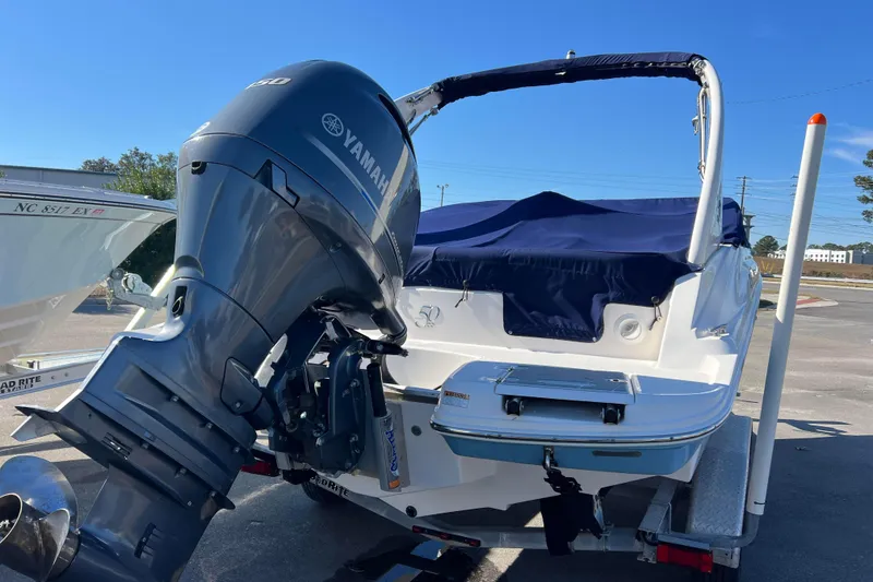 Slide: The Image of 2020 Regal 21 OBX boat with Yamaha outboard motor, covered and on trailer. - 3