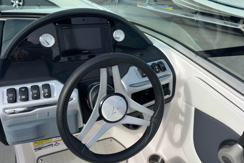 Slide: The Image of 2020 Regal 21 OBX boat dashboard with steering wheel and control panel. - 4