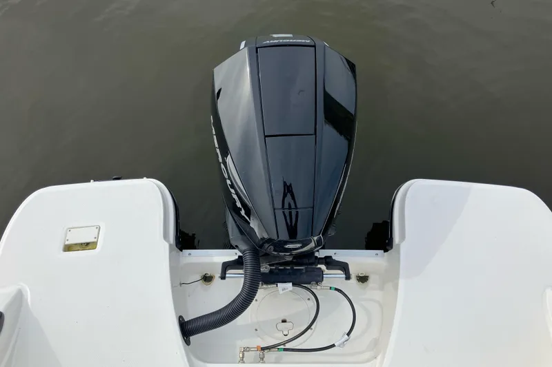 Slide: The Image of 2024 Trophy CC22 boat with a sleek black outboard motor on calm water. - 6