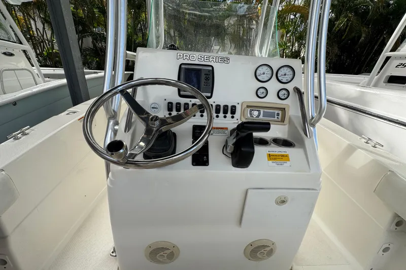 Slide: The Image of 2011 Sea Fox 226 Center Console boat dashboard with steering wheel and gauges. - 13