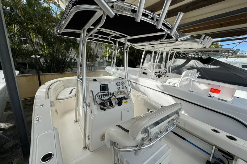 Slide: The Image of 2011 Sea Fox 226 Center Console boat with T-top and helm, docked in marina. - 20
