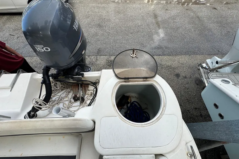 Slide: The Image of 2011 Sea Fox 226 Center Console boat with Yamaha 150 engine and open storage compartment. - 24