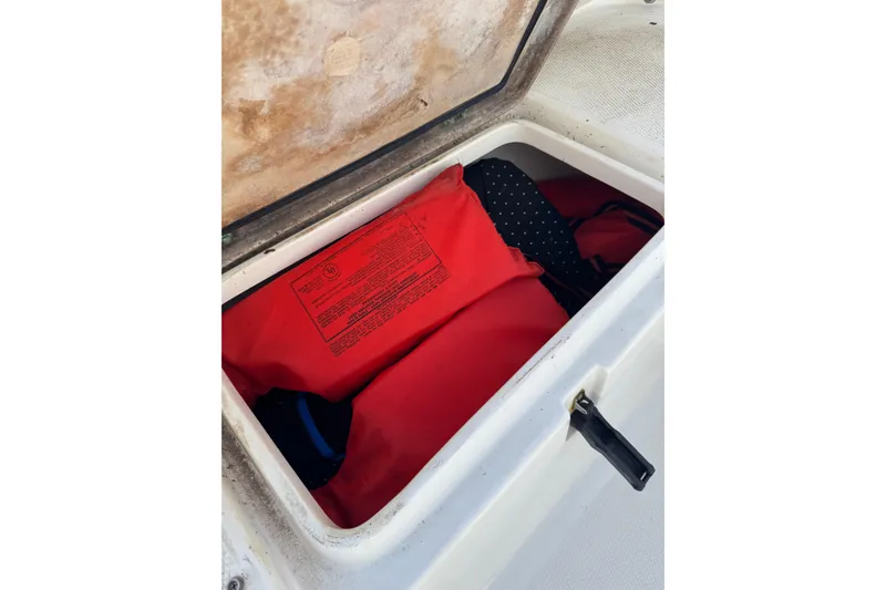 Slide: The Image of Storage compartment on 2011 Sea Fox 226 Center Console with red life jackets. - 25
