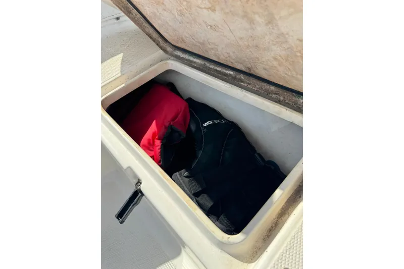 Slide: The Image of Storage compartment on 2011 Sea Fox 226 Center Console boat with life jackets inside. - 26