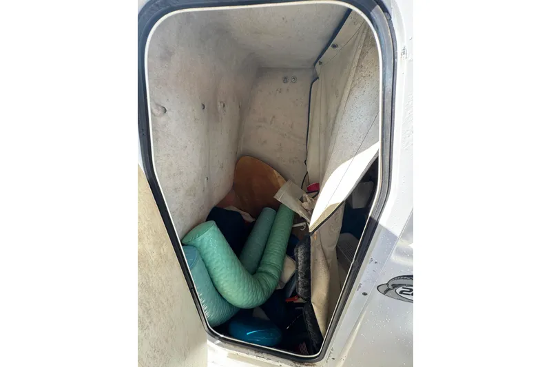 Slide: The Image of Storage compartment of a 2011 Sea Fox 226 Center Console boat, containing various items. - 27