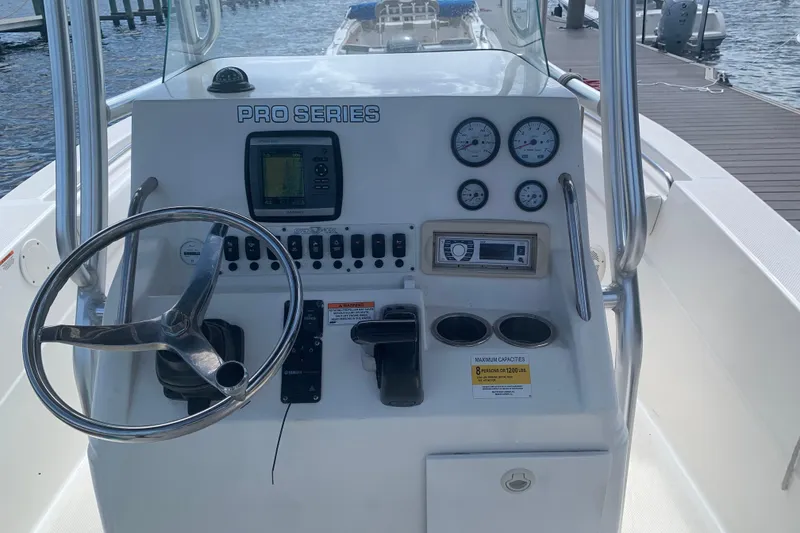 Slide: The Image of 2011 Sea Fox 226 Center Console boat dashboard with steering wheel and gauges. - 3