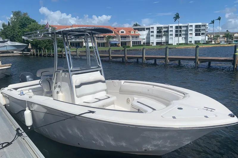 Slide: The Image of 2011 Sea Fox 226 Center Console boat docked by waterfront buildings. - 4