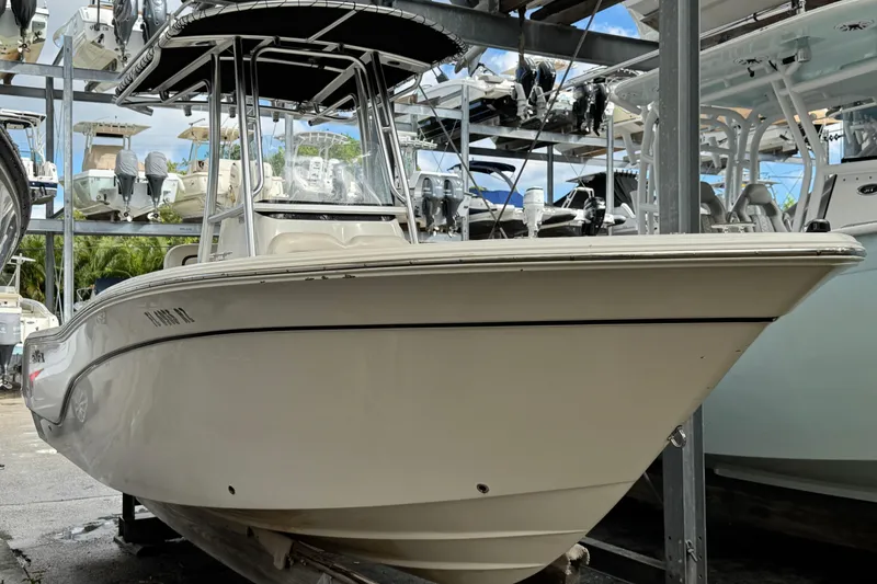 Slide: The Image of 2011 Sea Fox 226 Center Console boat in storage, surrounded by other vessels. - 7
