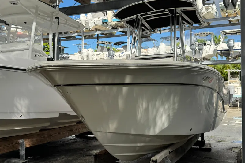 Slide: The Image of 2011 Sea Fox 226 Center Console boat in storage, surrounded by other vessels. - 8