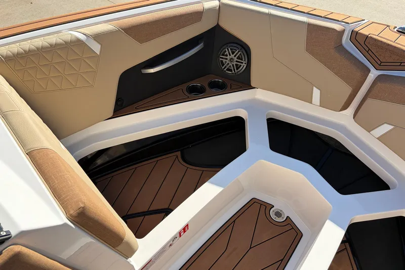 Slide: The Image of 2026 Nautique Super Air Nautique GS22 interior with tan seating and speaker system. - 20