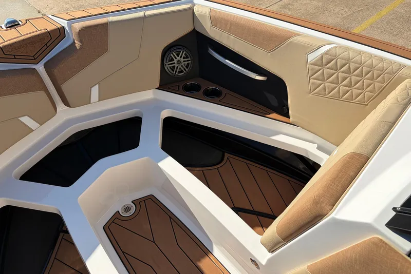 Slide: The Image of 2026 Nautique Super Air Nautique GS22 boat interior with tan upholstery and modern design. - 21