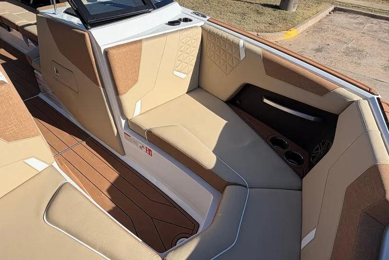 Slide: The Image of 2026 Nautique Super Air Nautique GS22 interior with beige upholstery and wood accents. - 24