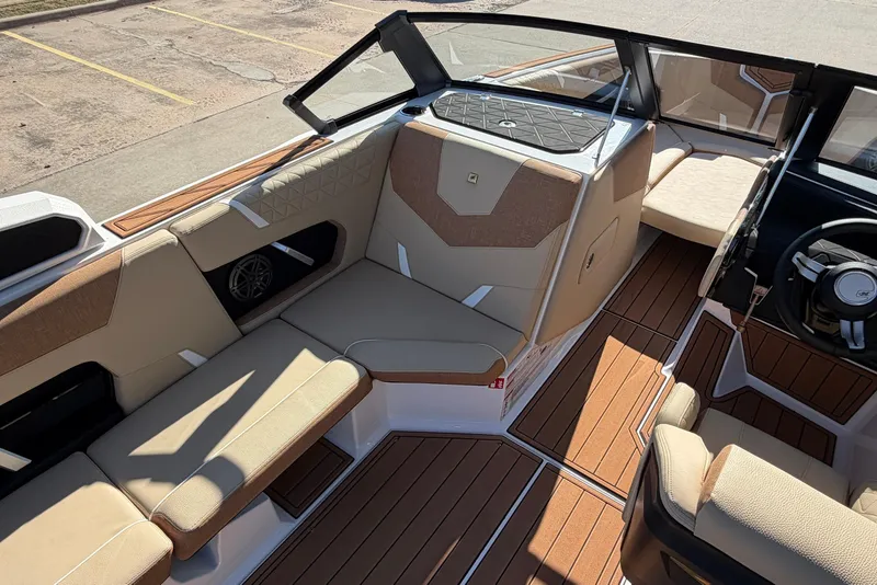 Slide: The Image of 2026 Nautique Super Air Nautique GS22 interior with tan seating and wood accents. - 26