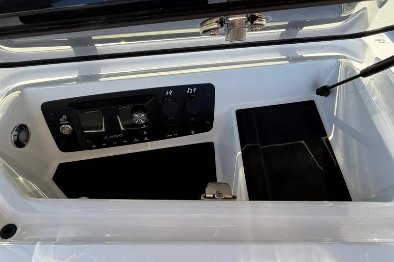 Slide: The Image of 2026 Nautique Super Air Nautique GS22 audio system with JL Audio controls in storage compartment. - 28