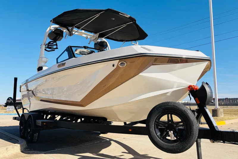Slide: The Image of 2026 Nautique Super Air Nautique GS22 boat on trailer, sleek design, sunny day. - 3